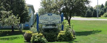 Eden Valley apartment for rent - the sign place apartments is in front of a green lawn and trees