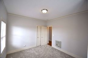 Oakland apartment for rent - a bedroom with white walls and a door to a closet