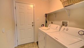 Duson house for rent - a washer and dryer in a laundry room with a white door