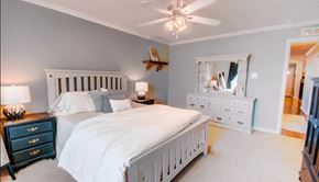 Duson house for rent - a bedroom with a white bed and a ceiling fan