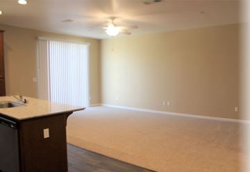 Merced house for rent - A kitchen area with a counter and a window with blinds.