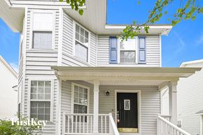 Raleigh house for rent - a white house with a black door and a porch