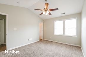 Raleigh house for rent - the spacious living room with ceiling fan and carpeting