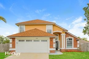 Orange Park house for rent - A house with a brown roof and a white garage door is for sale.