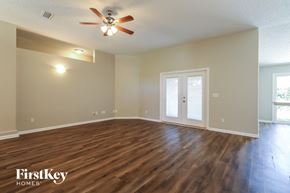Fleming Island house for rent - the spacious living room with hardwood flooring and a ceiling fan