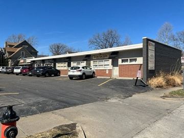 Kansas City apartment for rent - A parking lot with a fire hydrant in front of a building.