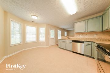 Jonesboro house for rent - a kitchen with a sink and a dishwasher and a counter top