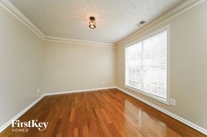 Jonesboro house for rent - the living room with wood floors and a large window