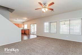 San Tan Valley house for rent - A spacious room with a ceiling fan and carpeted floor.