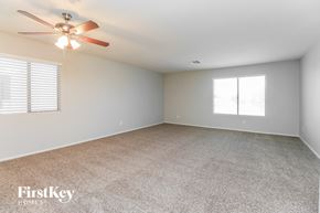 San Tan Valley house for rent - A room with a ceiling fan and carpeted floor.