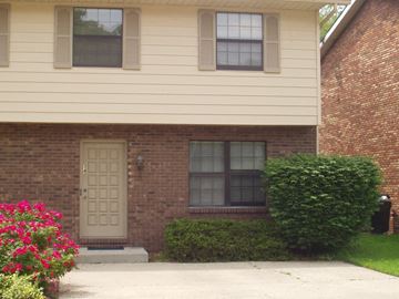 Huntington house for rent - the front of a brick house with a white door