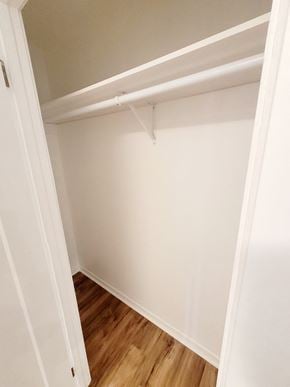 Montréal apartment for rent - an empty closet with a wooden floor and white walls