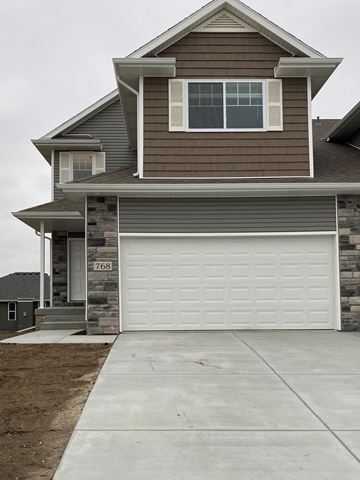 Lincoln house for rent - A two-story house with a garage door.