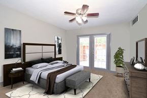 Fort Worth apartment for rent - a bedroom with a bed and a ceiling fan
