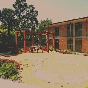 Fort Worth apartment for rent - a playground with a swing set in front of a building