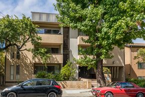 Oakland apartment for rent - A black car is parked in front of a red car.