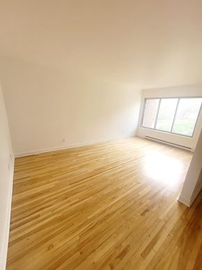 Saint-Laurent apartment for rent - A room with wooden flooring and a window letting in light.