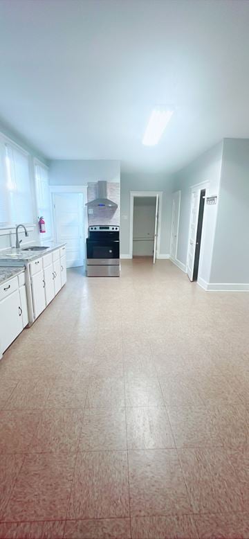 Newfield apartment for rent - A kitchen with white cabinets and a black stove top oven.