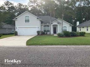 St Johns house for rent - a white house with a driveway and a garage door