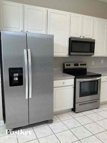 St Johns house for rent - a kitchen with a stainless steel refrigerator and a stove