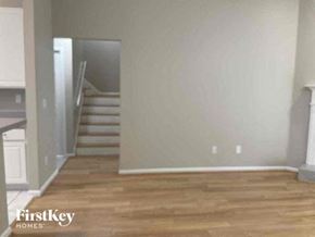 St Johns house for rent - an empty living room with a wooden floor and stairs