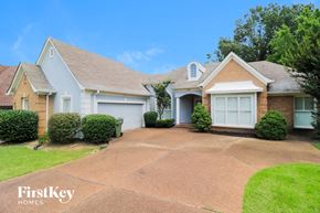 Memphis house for rent - a white house with a driveway and a white garage door