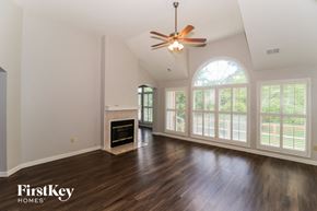 Memphis house for rent - an empty living room with a large window and a ceiling fan