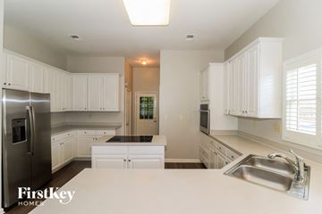 Memphis house for rent - a white kitchen with a sink and a refrigerator