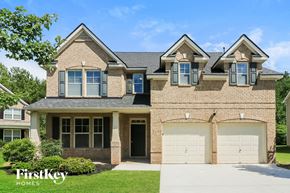 Powder Springs house for rent - a tan brick house with two garage doors