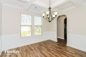 Powder Springs house for rent - an empty dining room with a chandelier and a window