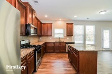Powder Springs house for rent - a kitchen with wooden cabinets and granite counter tops and stainless steel appliances