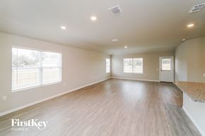 San Antonio house for rent - an empty living room with wood flooring and white walls
