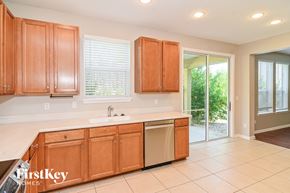 Fernandina Beach house for rent - a kitchen with wooden cabinets and a sink and a dishwasher
