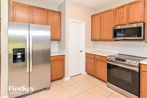 Fernandina Beach house for rent - a kitchen with stainless steel appliances and wooden cabinets