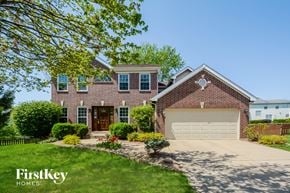 O Fallon house for rent - a large brick house with a white garage door