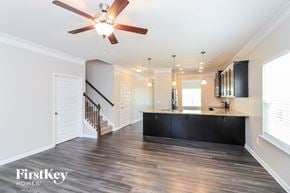 Canton house for rent - A spacious room with a staircase and a ceiling fan.