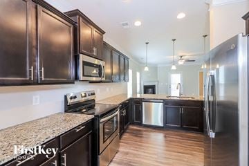 Canton house for rent - A kitchen with dark wood cabinets and stainless steel appliances.