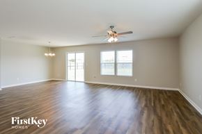 St Augustine house for rent - an empty living room with wood floors and a ceiling fan