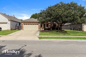 Cibolo house for rent - A tree in front of a house with a sign that says FirstKey Homes.