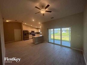 Cape Coral house for rent - a large empty living room with a ceiling fan