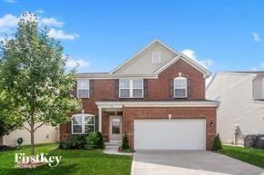 Greenwood house for rent - a brick house with a white garage door