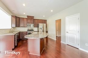 Greenwood house for rent - a kitchen with wood flooring and granite counter tops and