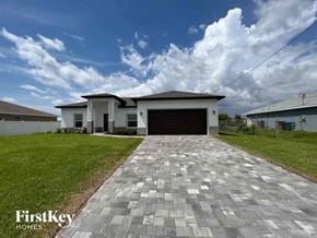 Cape Coral house for rent - a house with a driveway and a garage door