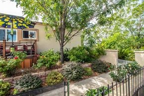 Farmington apartment for rent - a backyard with a house and a patio with an umbrella