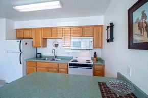 Farmington apartment for rent - a kitchen with wooden cabinets and a counter top
