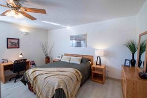 Farmington apartment for rent - a bedroom with a bed and a ceiling fan