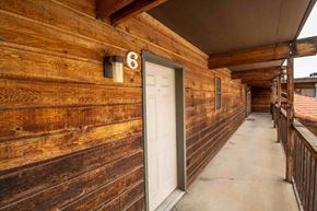 Farmington apartment for rent - the entrance to a building with a wooden wall and a white door