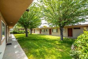Farmington apartment for rent - a yard in front of a building with trees