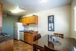 Farmington apartment for rent - a kitchen with a dining table and a refrigerator