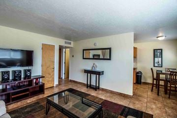 Farmington apartment for rent - a living room and dining room with a tv and a table